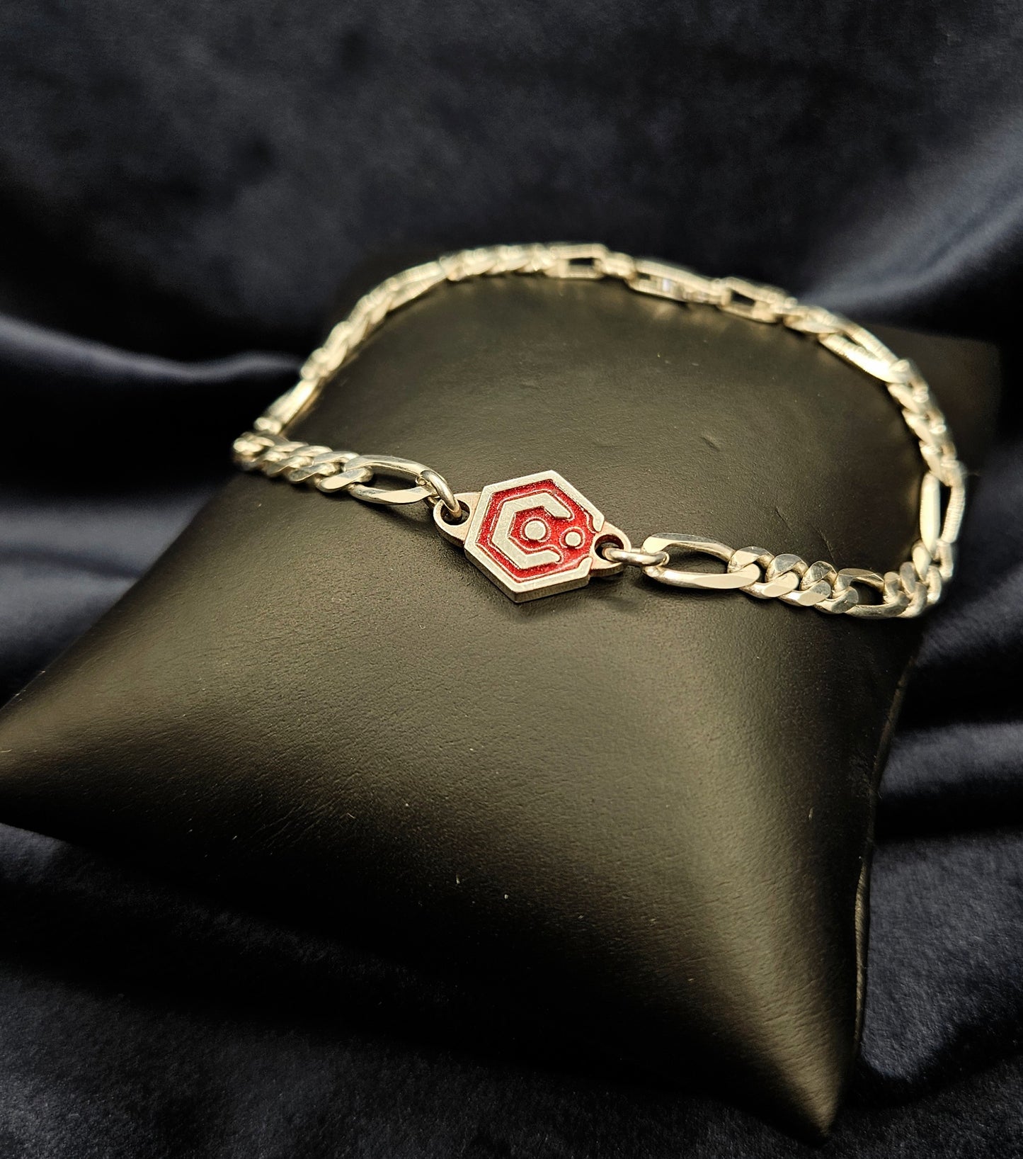 Sterling Silver Figaro Chain Bracelet With Red Catalyst Tag