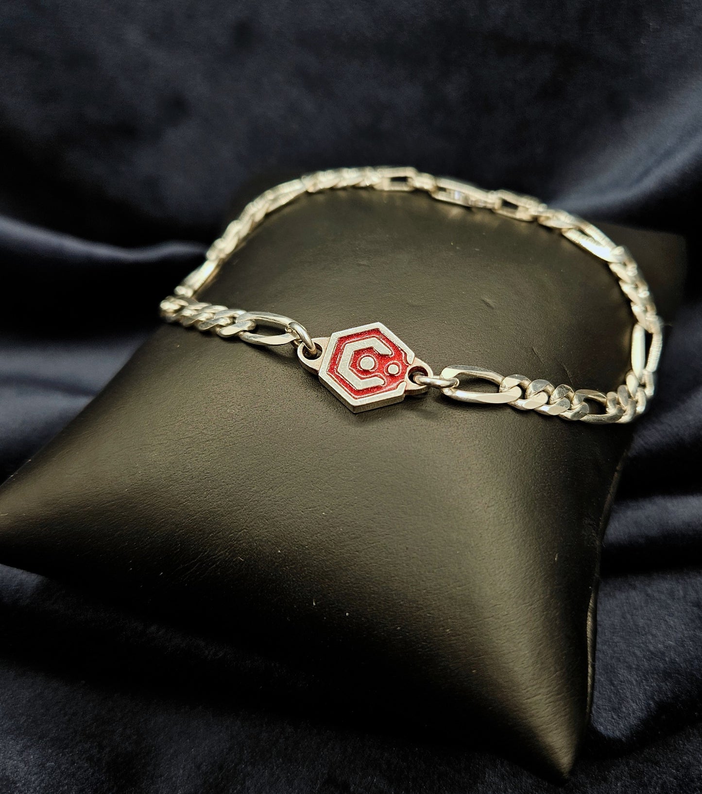 Sterling Silver Figaro Chain Bracelet With Red Catalyst Tag